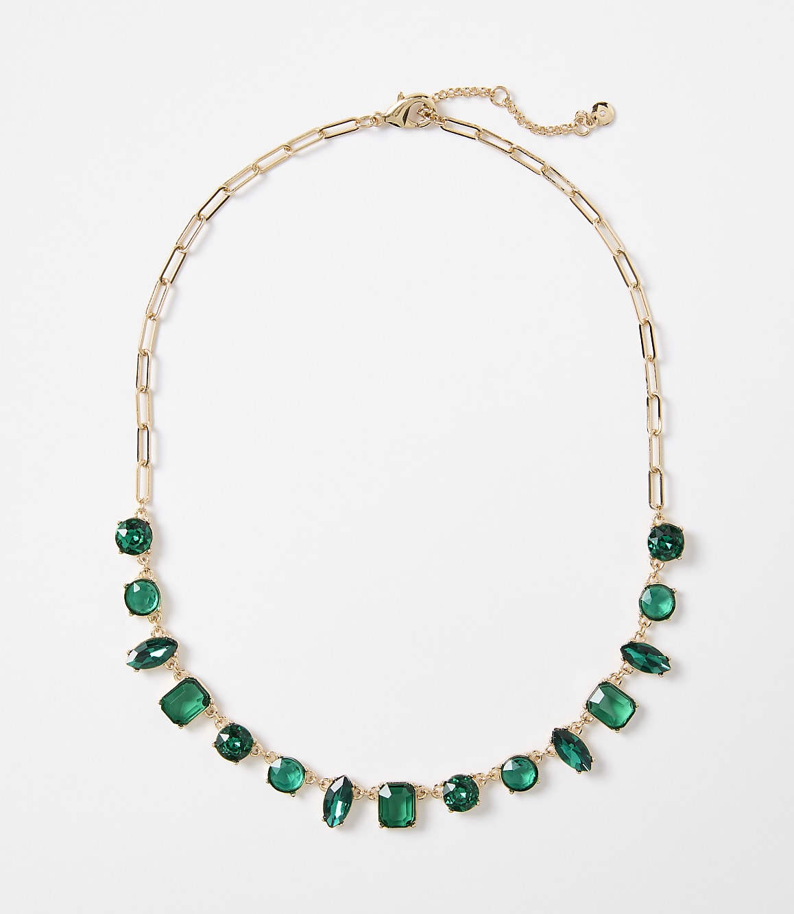 A gold chain necklace with various green gemstones is displayed against a plain white background.