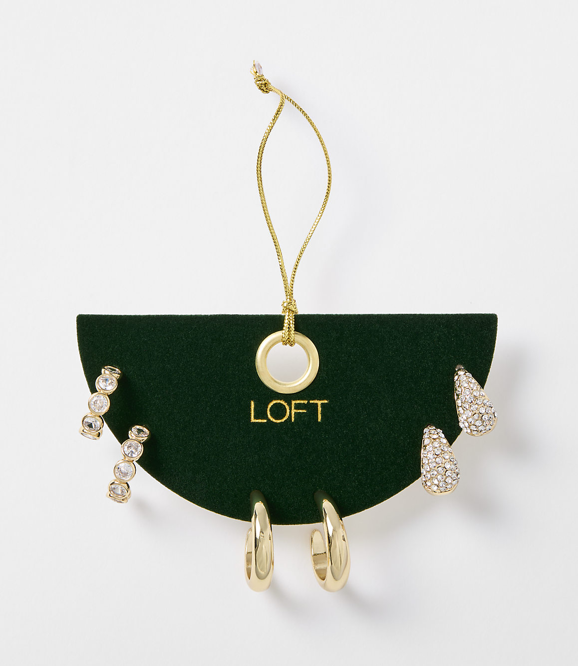 A set of gold-toned earrings, including studs and hoops, are displayed on a dark green card with the "LOFT" logo, against a plain white background.