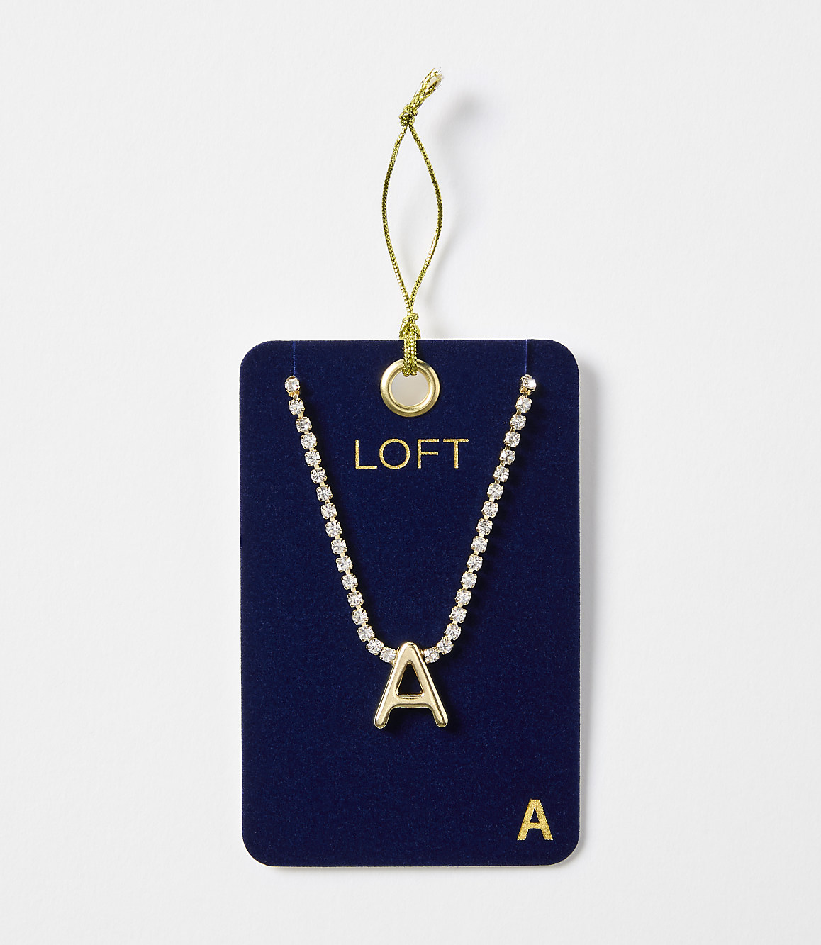 A gold letter "A" necklace with a rhinestone chain is displayed on a dark blue card with the "LOFT" logo, against a plain white background.