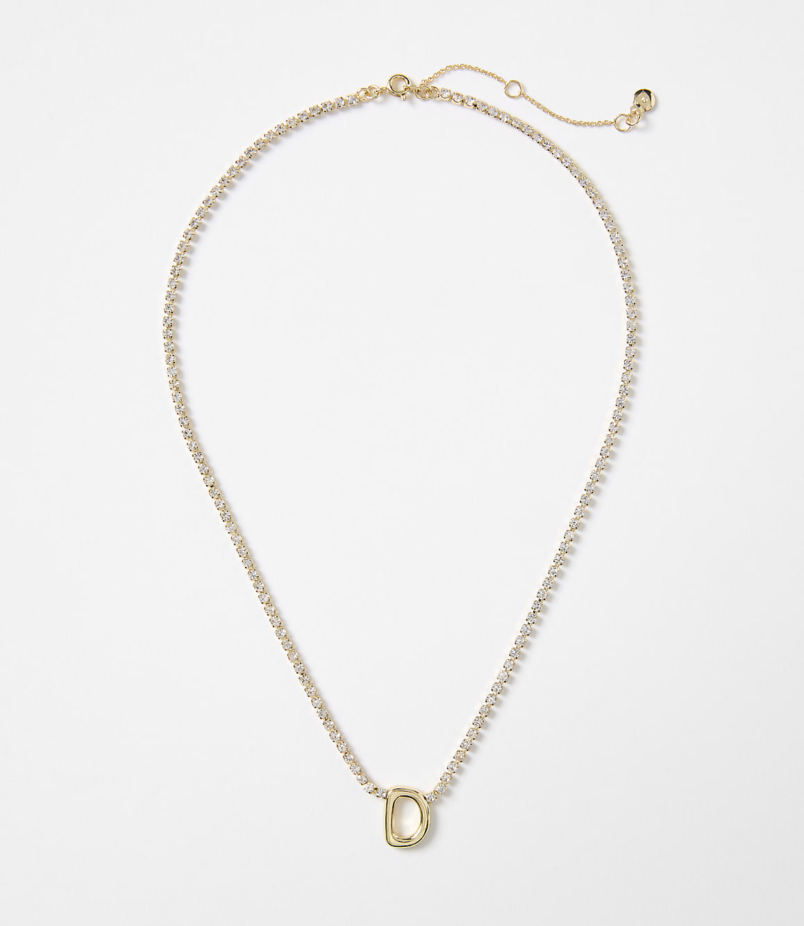 A delicate gold necklace with a single letter "D" charm rests on a plain white background.