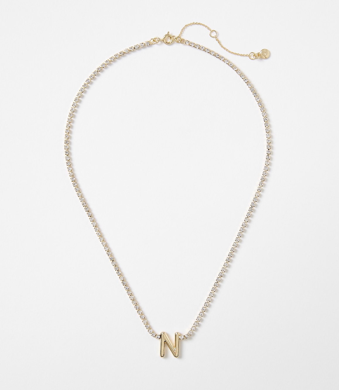 A gold letter "N" charm hangs from a delicate, diamond-encrusted chain against a plain white background.