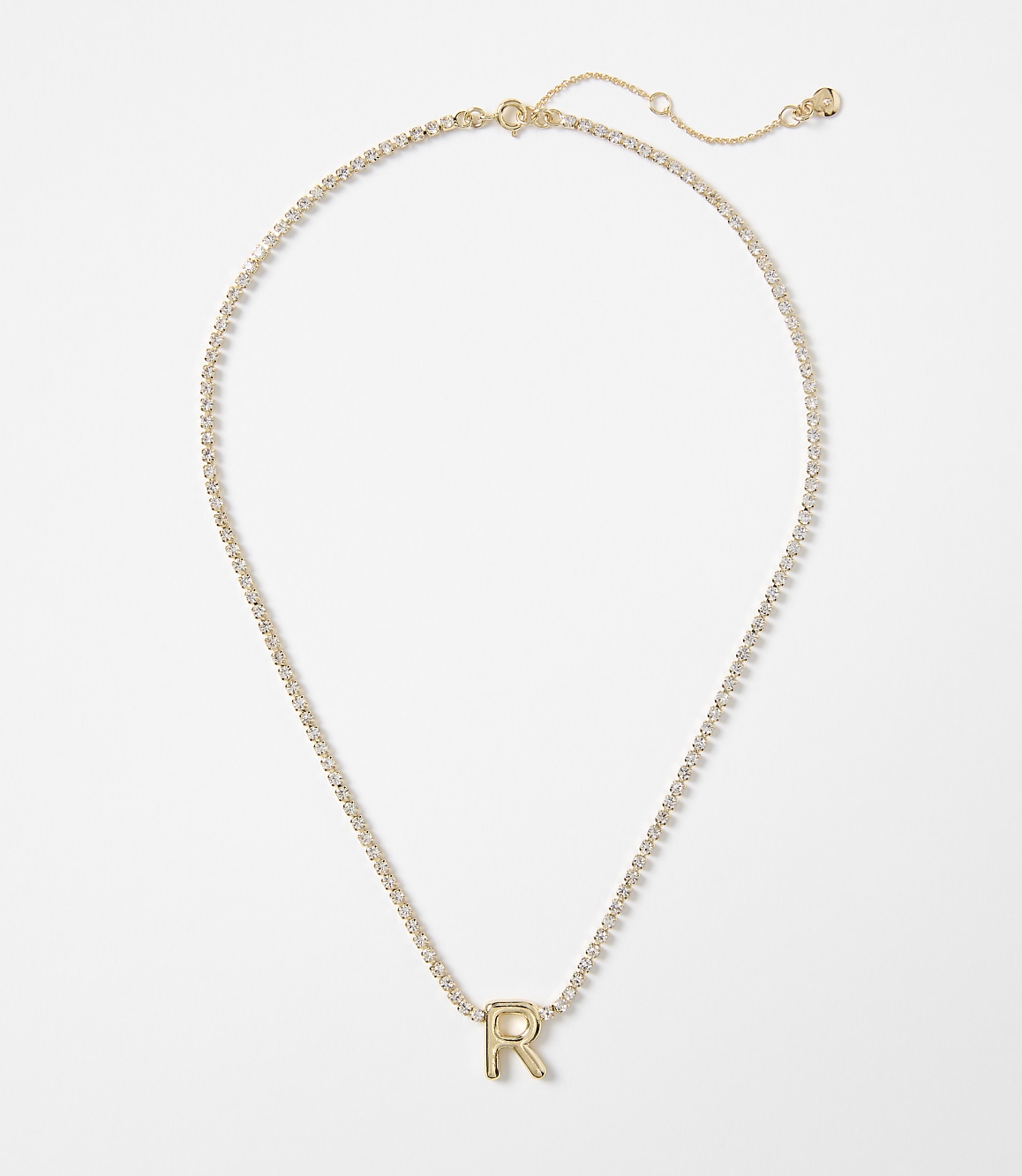 A gold letter "R" pendant on a delicate, sparkling chain rests against a plain white background.