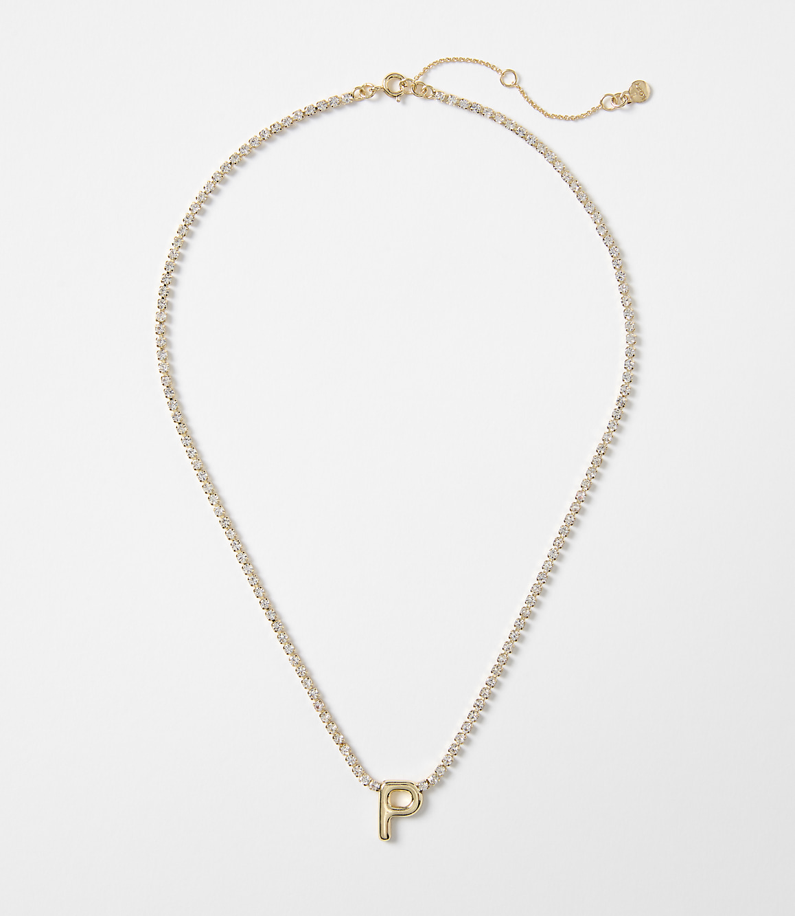 A gold letter "P" pendant on a delicate, diamond-studded chain rests against a plain white background.
