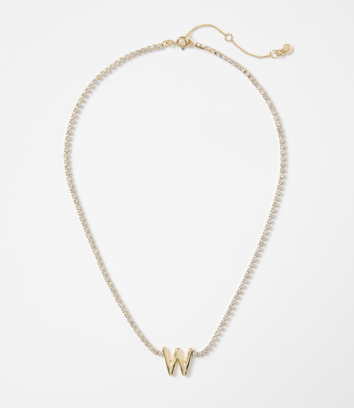 A gold letter "W" pendant is centered on a delicate, diamond-encrusted chain against a plain white background.