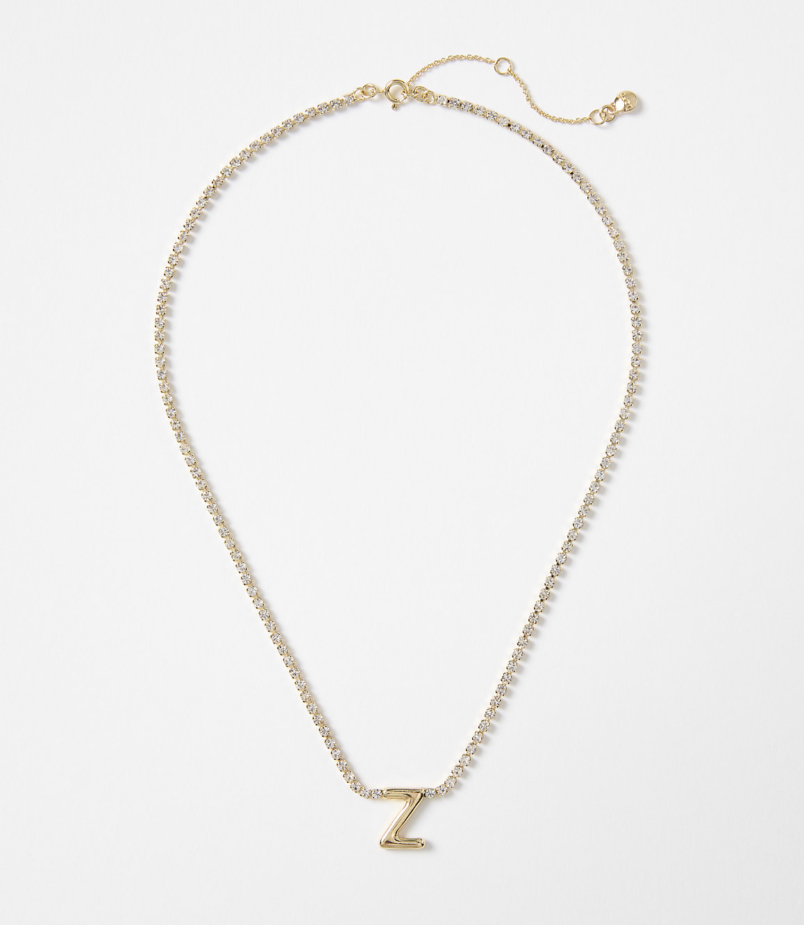 A gold letter "Z" pendant necklace with a delicate chain rests on a plain white background.