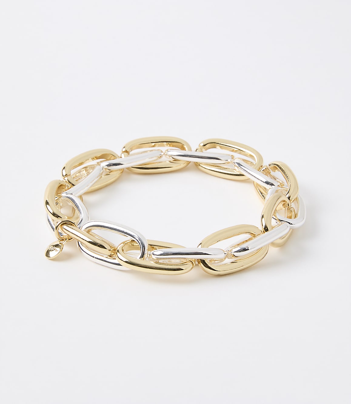 A chunky, two-toned gold and silver link bracelet rests on a plain white background.