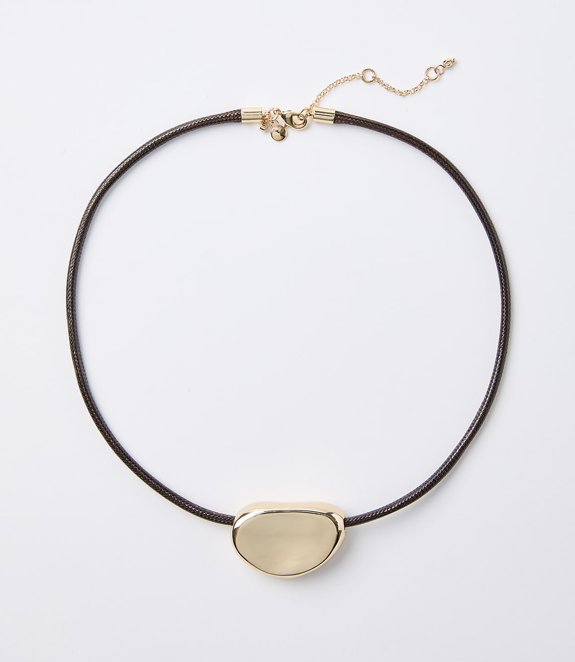 A dark brown cord necklace with a smooth, gold-toned pendant rests on a plain white background.