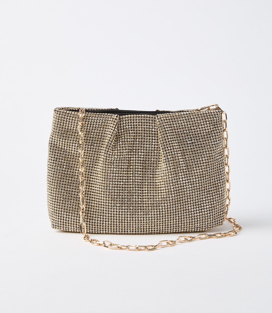 A gold rhinestone clutch with a delicate gold chain rests on a plain white background.