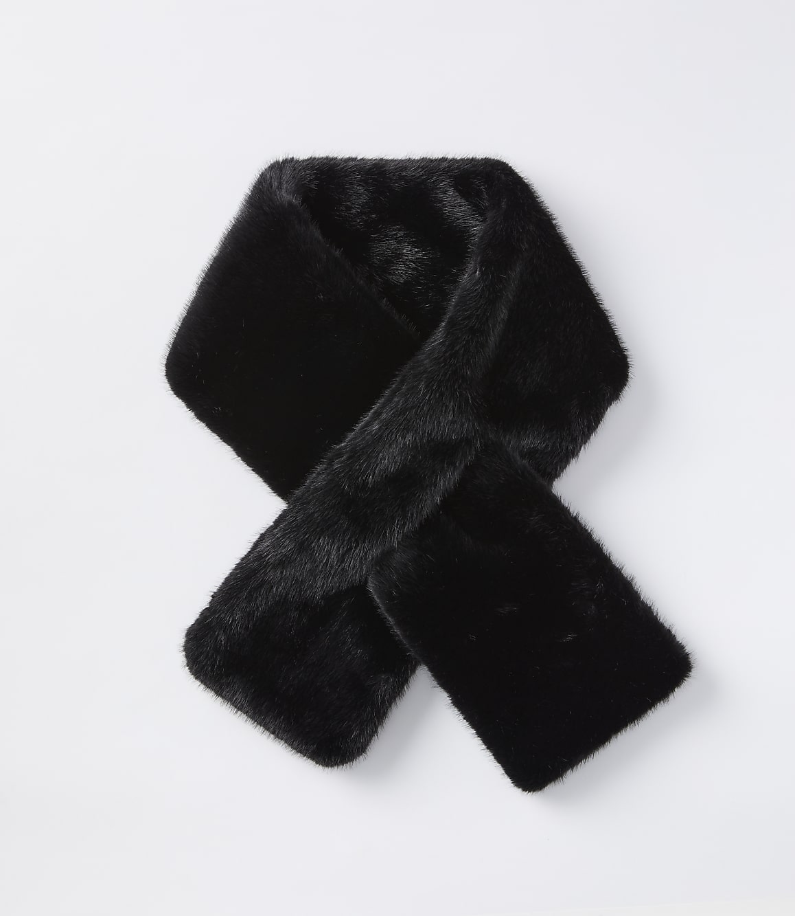 A black faux fur scarf is laid out in a knot on a plain white background.