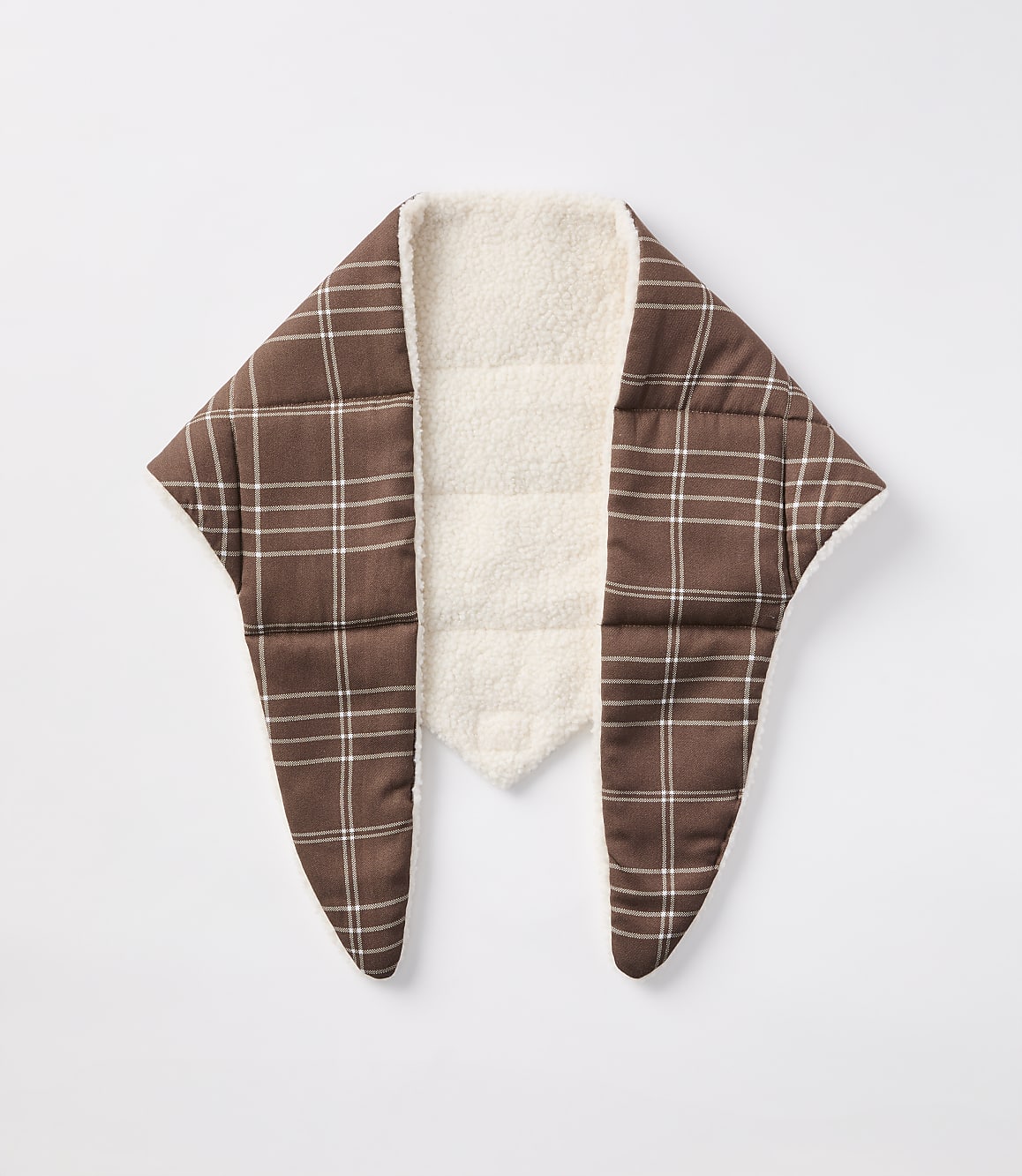 A brown plaid scarf with a cream sherpa lining is laid flat against a plain white background.