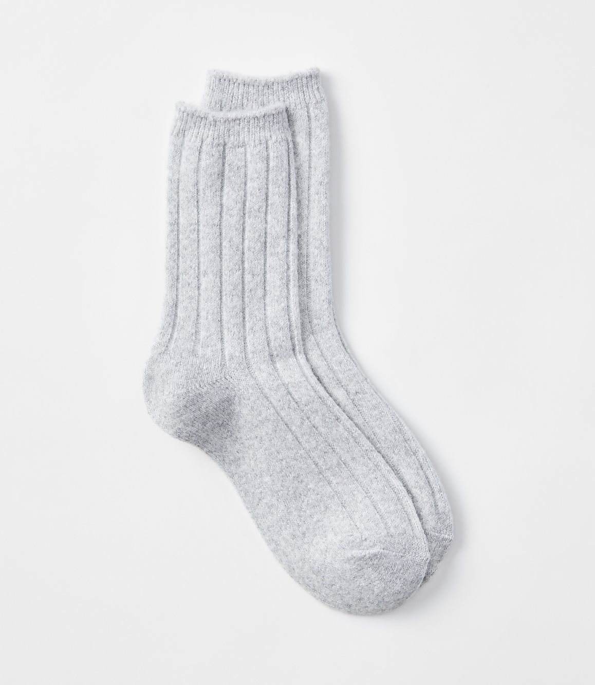 A pair of light gray ribbed socks rests on a plain white background.