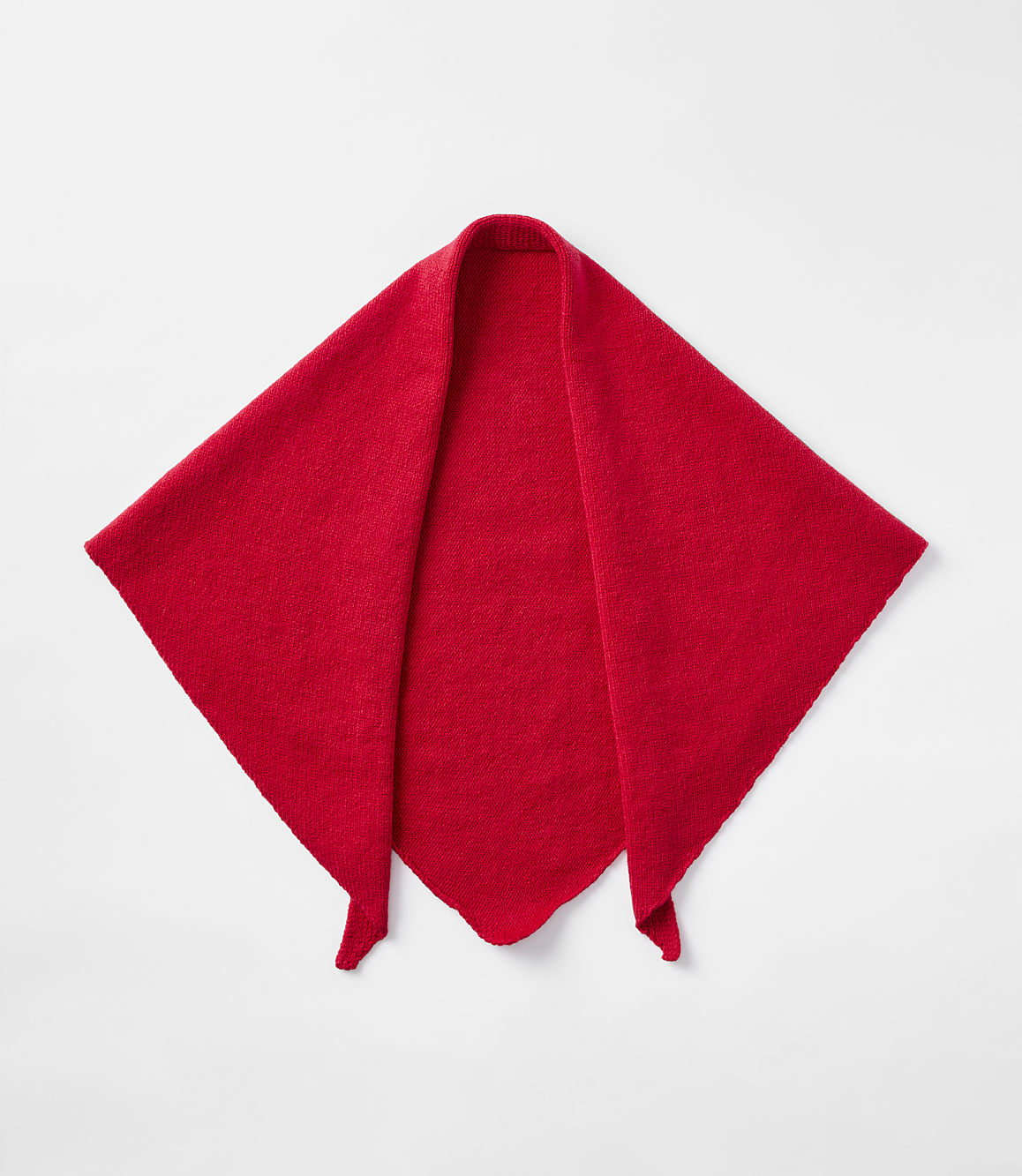 A bright red, diamond-shaped scarf with pointed ends lies flat against a plain white background.
