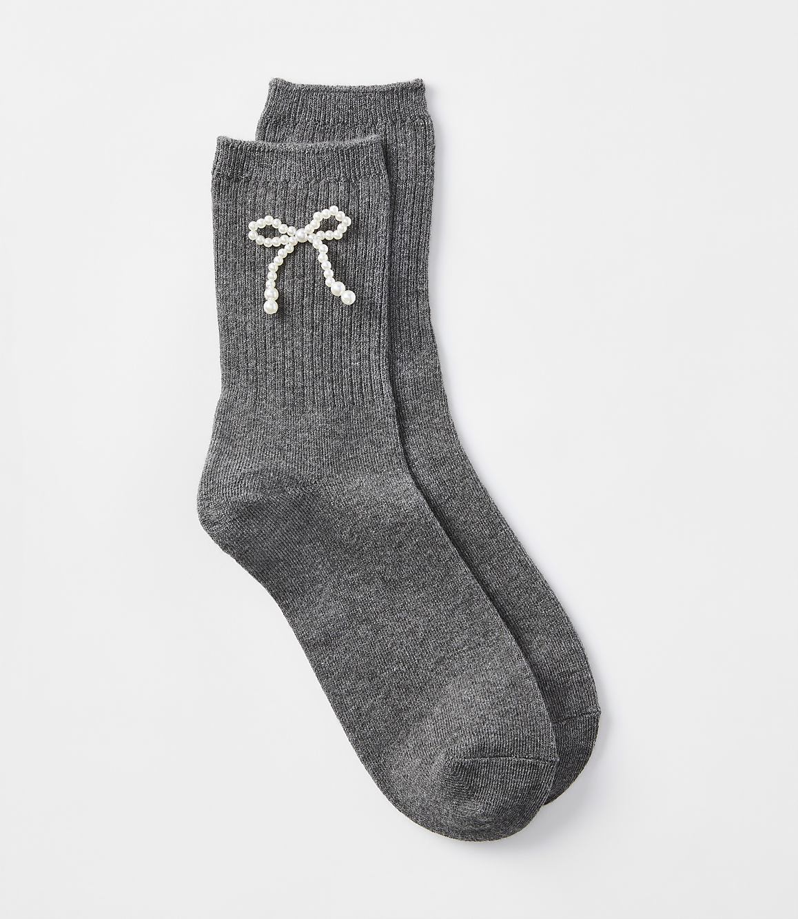 A pair of dark gray ribbed socks with a pearl bow detail rests on a plain white background.