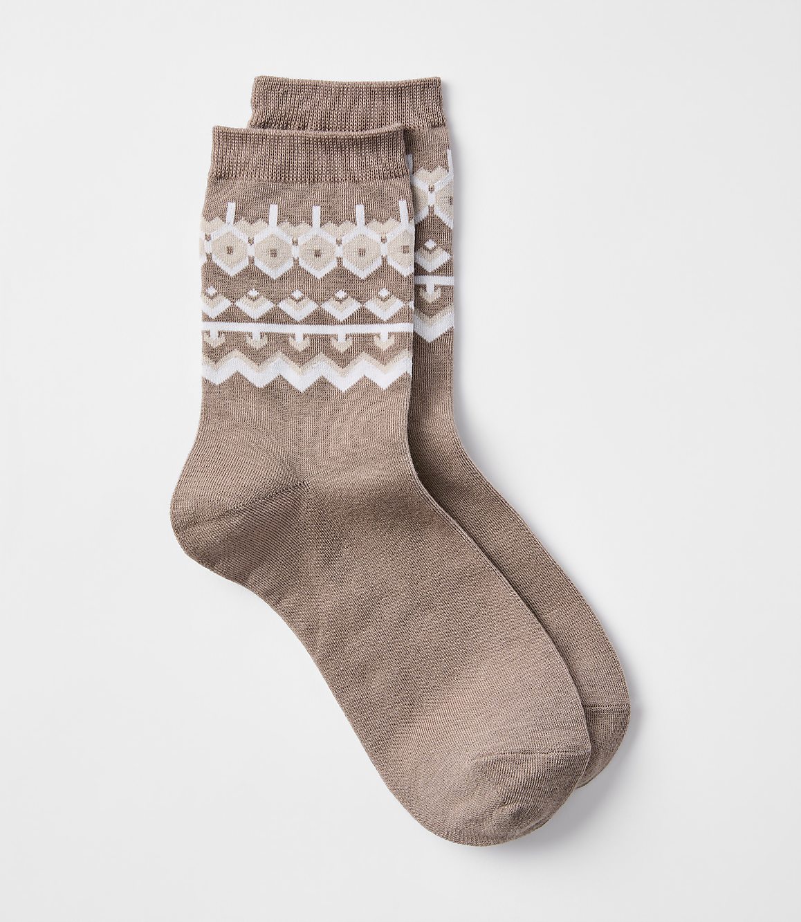 A pair of brown socks with a fair isle pattern are laid out against a plain white background.