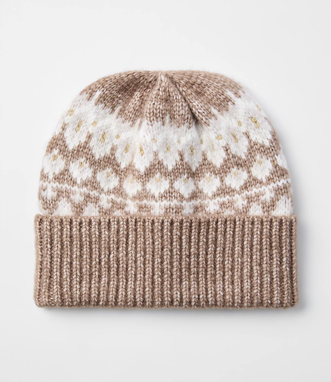 A knitted beanie with a ribbed brim in a light brown color is in the foreground, while the background is a plain white surface.