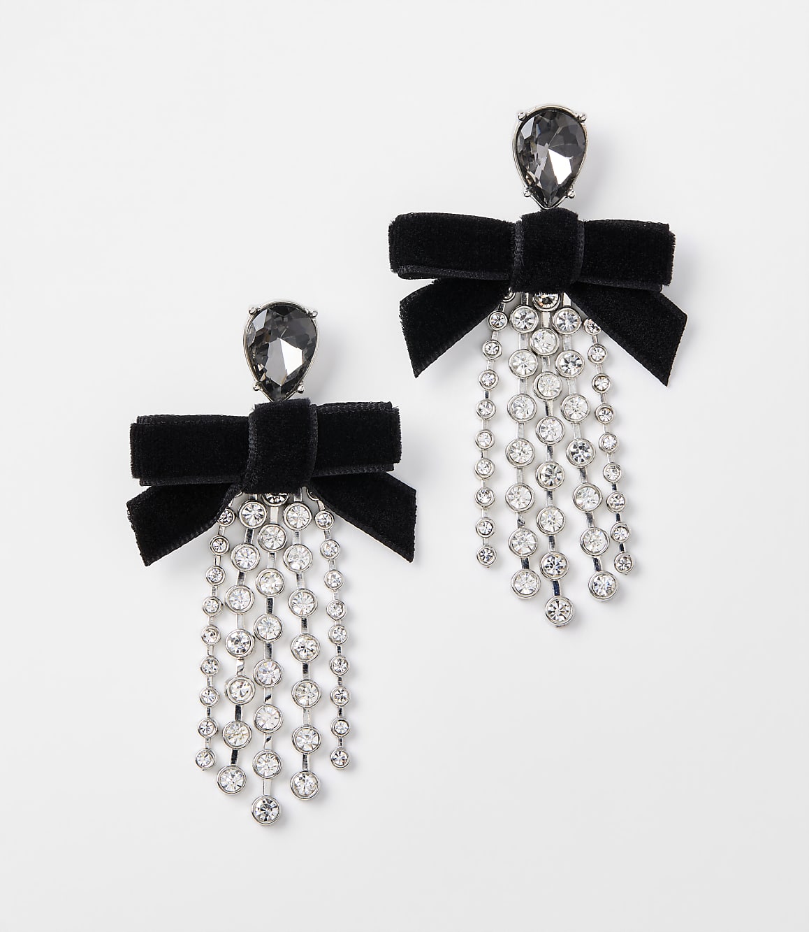 A pair of black velvet bow earrings with dangling crystal accents are displayed against a plain white background.