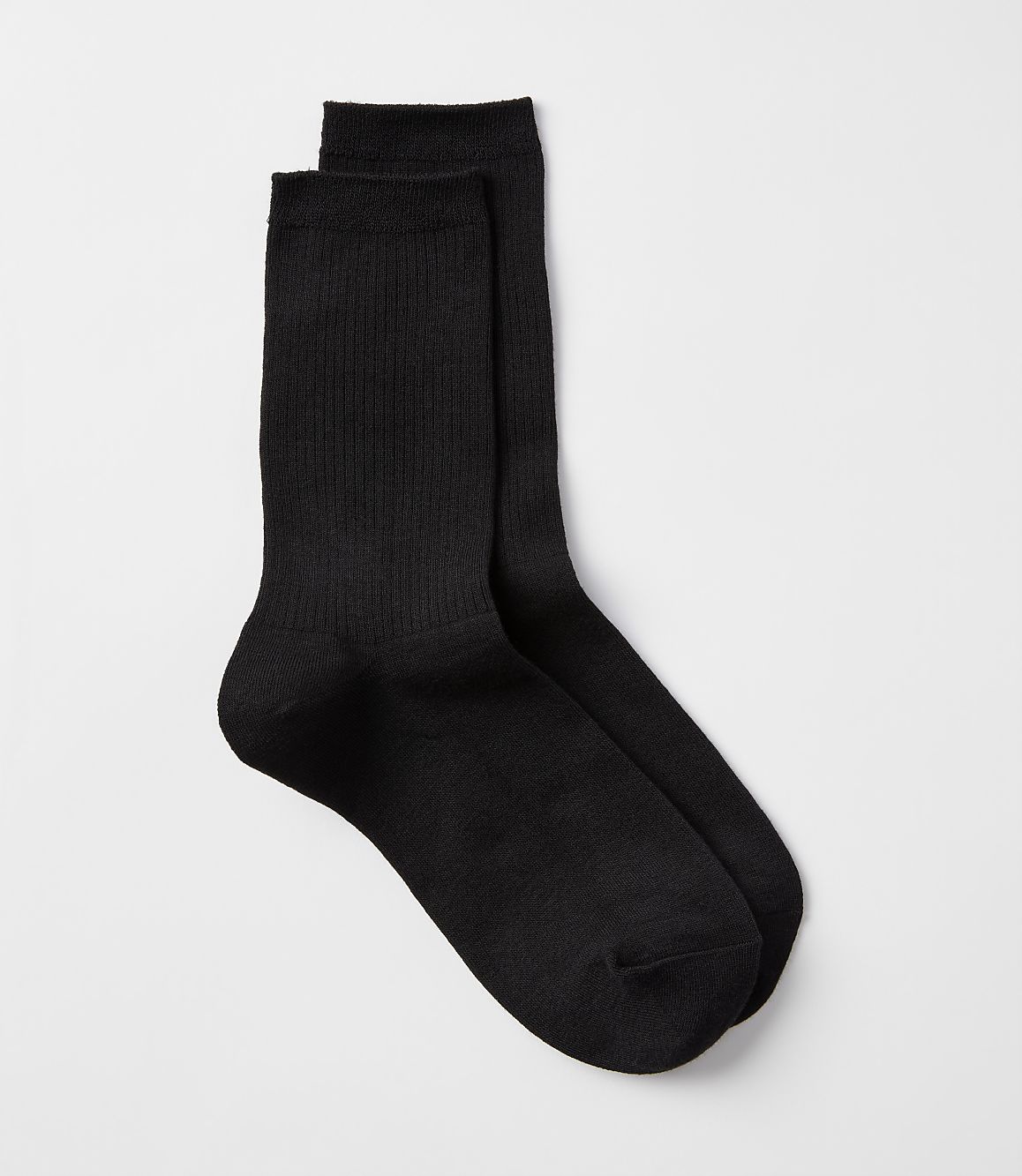 A pair of black ribbed socks rests on a plain white background.