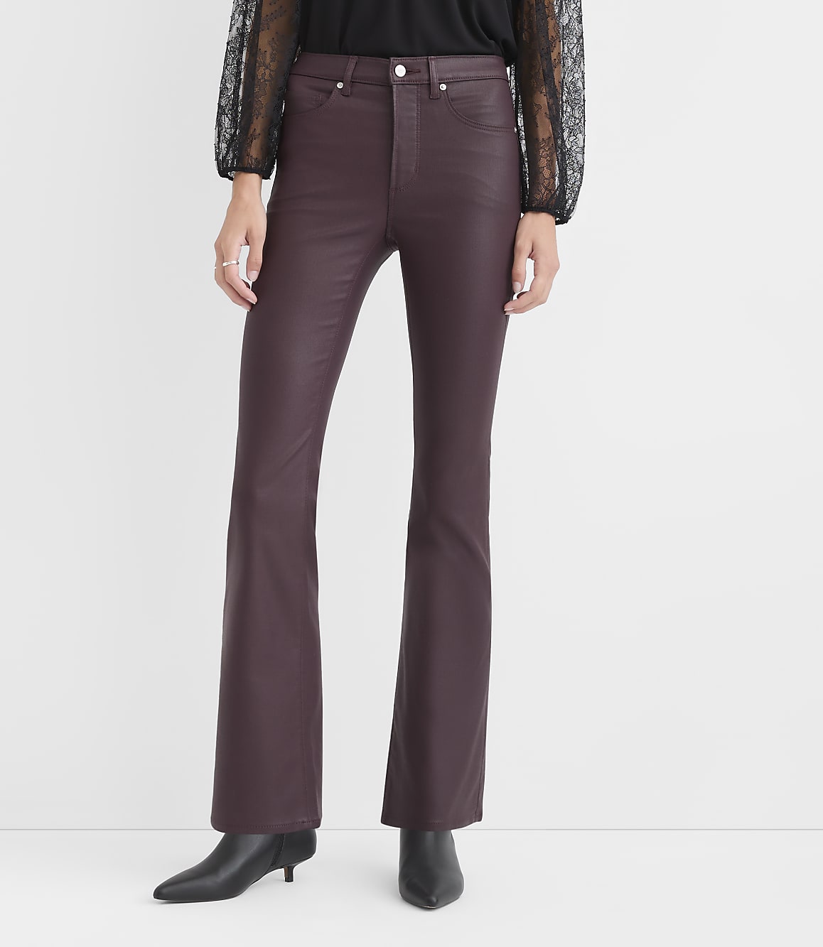 A person wears burgundy faux-leather flare pants and black boots against a plain white background.