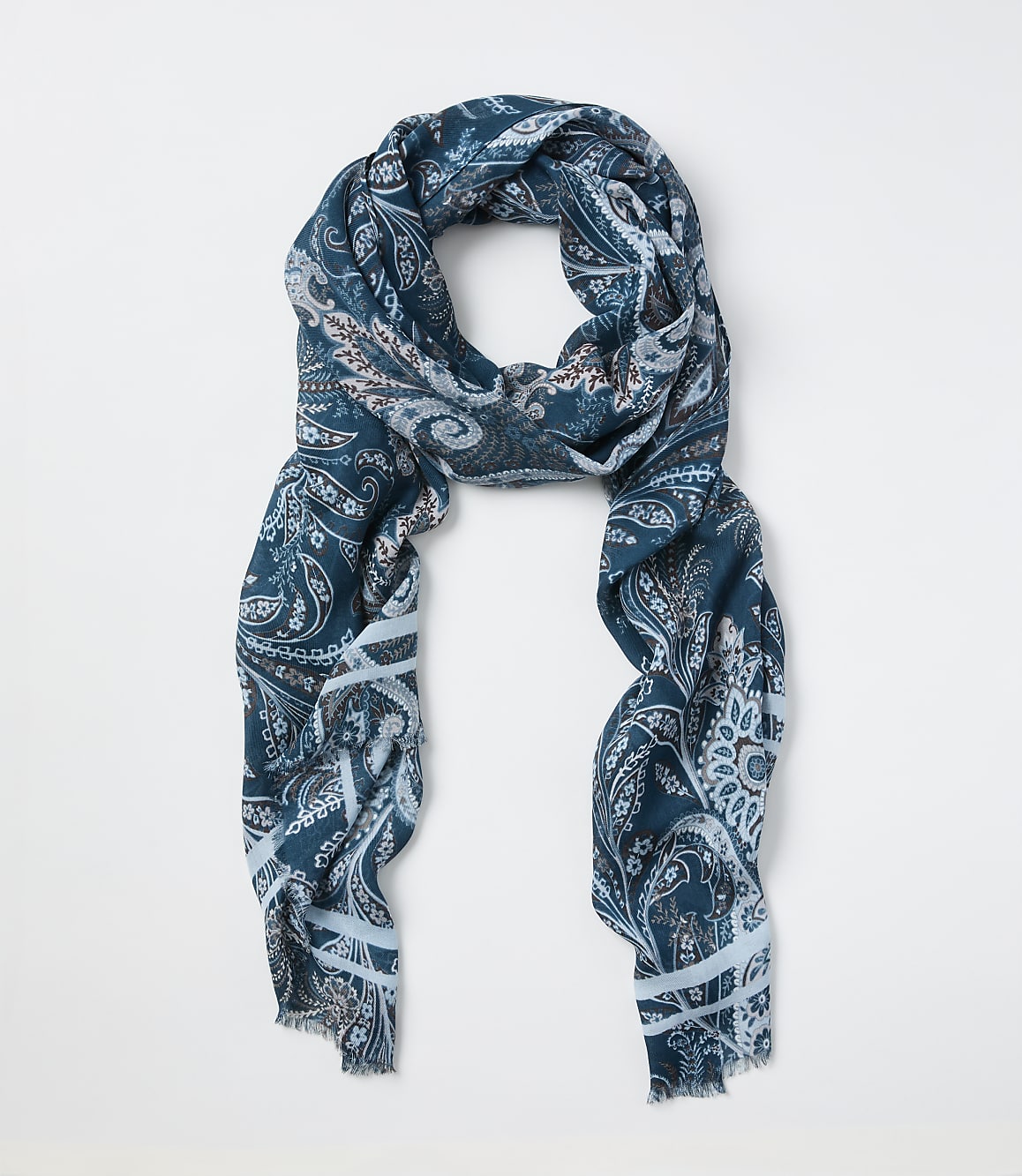 A teal paisley-patterned scarf is laid out against a plain white background.