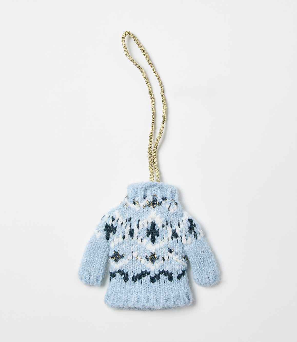 A small, blue knitted sweater ornament with a gold string hangs against a plain white background.