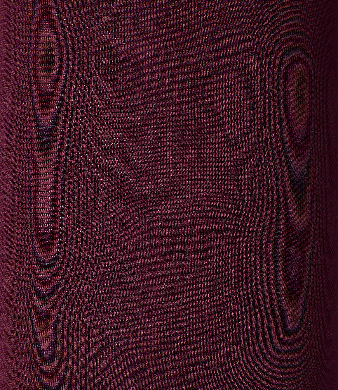 A close-up of a deep burgundy fabric texture fills the entire foreground and background.