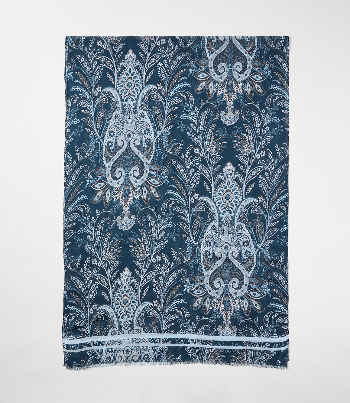 A blue and white paisley patterned shawl is centered against a plain white background.