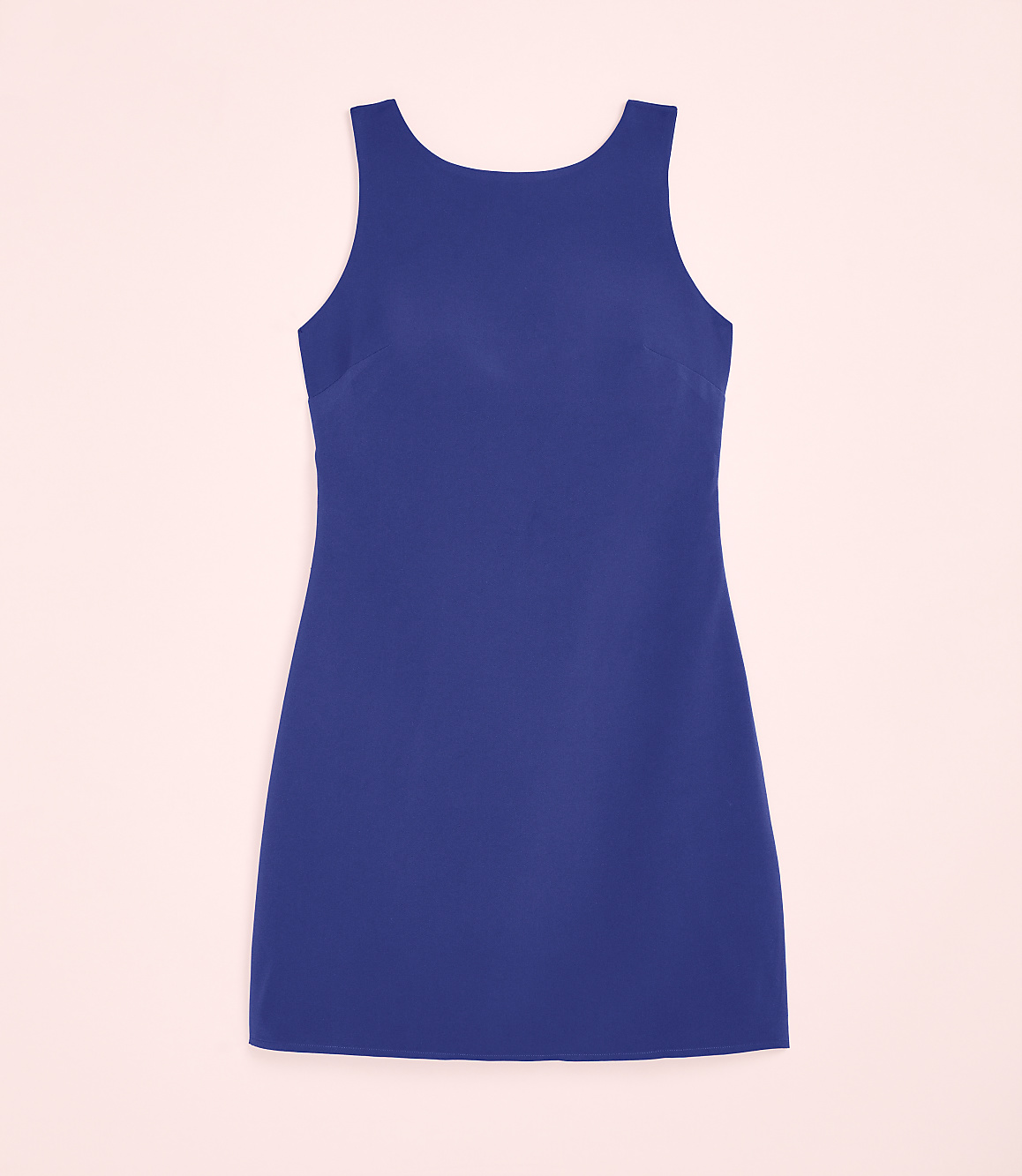 A sleeveless royal blue dress is centered against a pale pink background.