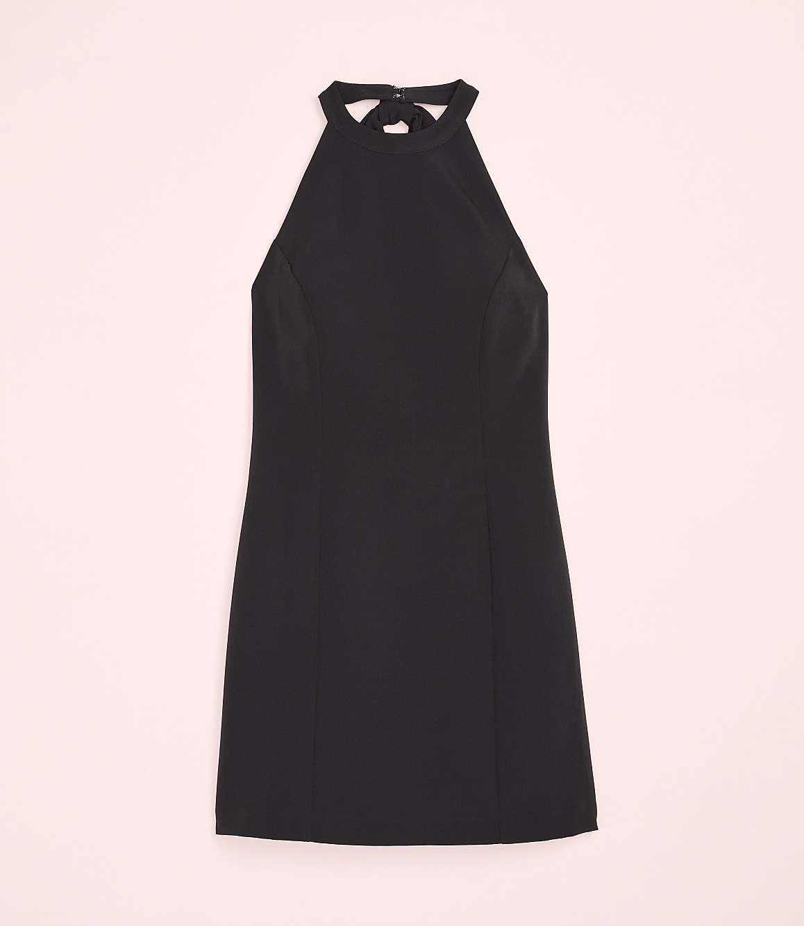 A black halter-neck dress is centered against a solid light pink background.
