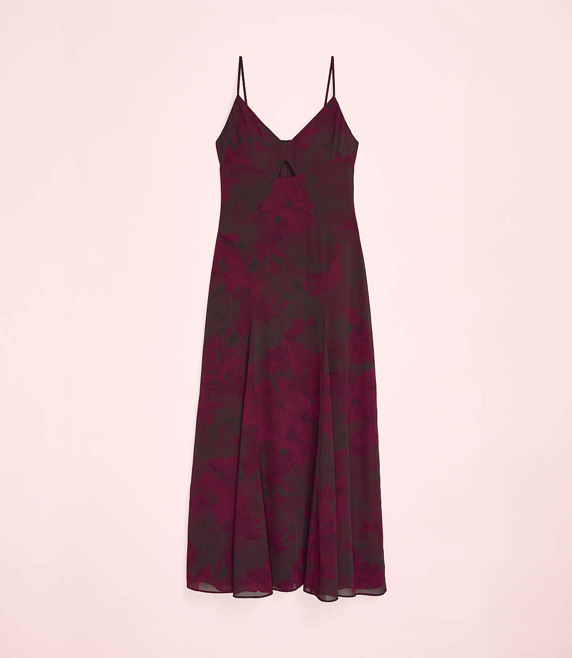 A maroon floral print slip dress is centered against a plain light pink background.