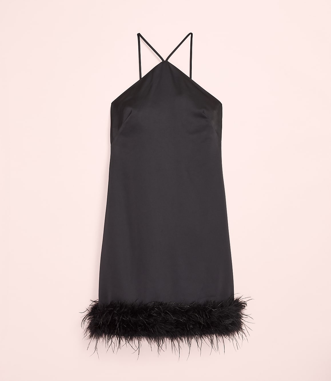 A short black satin dress with feather trim at the hem is centered against a pale pink background.