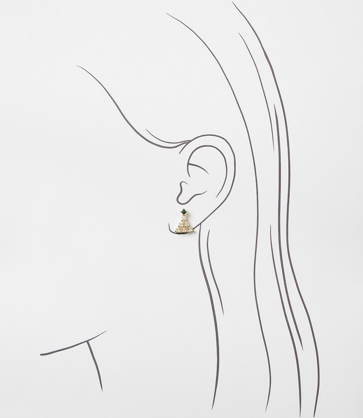 A small gold and green gemstone earring is placed on a minimalist line drawing of a woman's profile against a plain white background.