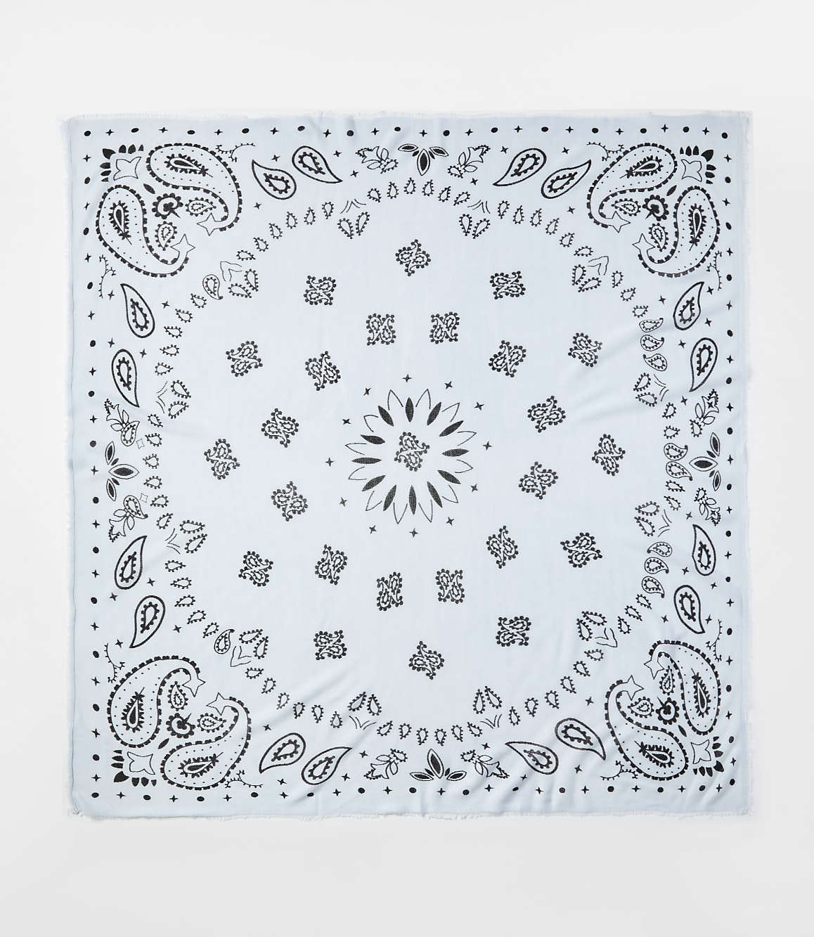 A light blue bandana with black paisley patterns is centered against a plain white background.
