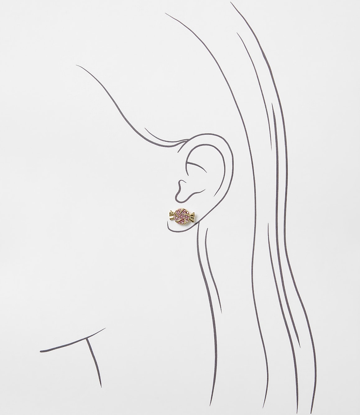 A small pink candy-shaped earring is worn on the ear of a minimalist line drawing of a woman's profile against a plain white background.