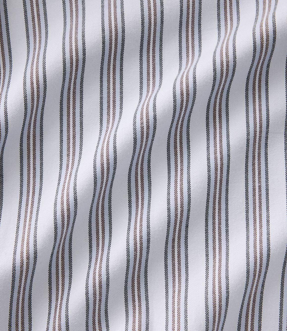 Vertical brown and grey stripes run across a white, undulating fabric background.