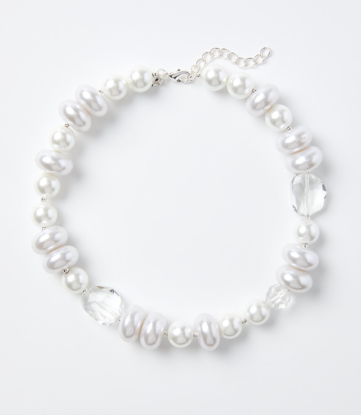 A white pearl and crystal necklace rests on a plain white background.
