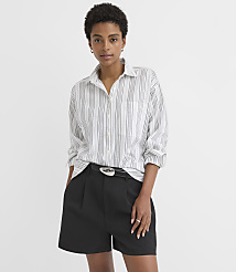 A woman in a striped shirt and black shorts stands against a plain white background. carousel Product Image 1