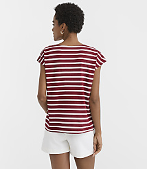 A woman in a striped shirt and white shorts stands against a plain white background. carousel Product Image 3