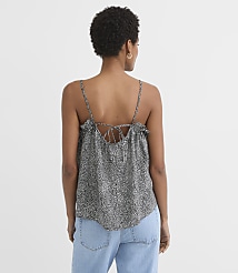 A woman in a patterned camisole and jeans stands against a plain white background. carousel Product Image 2