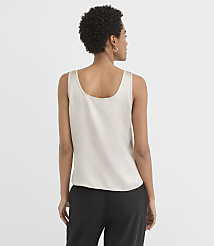 A woman in a light-colored tank top and black pants stands against a plain white background. carousel Product Image 2