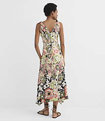 A woman in a patterned dress stands against a plain white background. carousel Product Image 3