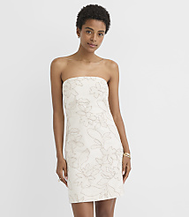 A woman in a strapless floral dress stands against a plain white background. carousel Product Image 1