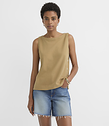 A woman in a tan sleeveless top and denim shorts stands against a plain white background. carousel Product Image 1