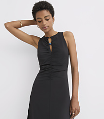 A woman in a black ruched dress with a keyhole neckline stands against a plain white background. carousel Product Image 3
