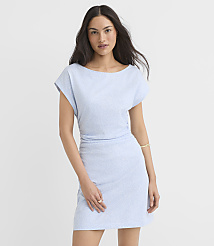 A woman in a light blue patterned dress stands against a plain white background. carousel Product Image 1