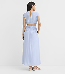 A woman in a light blue cutout maxi dress stands against a plain white background. carousel Product Image 3