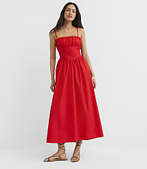A woman in a red midi dress stands against a plain white background. carousel Product Image 1