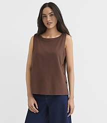 A woman in a brown sleeveless top and blue pants stands against a plain white background. carousel Product Image 1