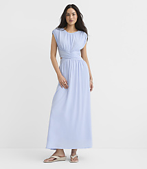 A woman in a light blue dress stands against a plain white background. carousel Product Image 2