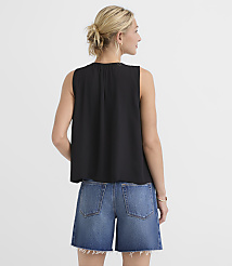 A woman in a black sleeveless top and denim shorts stands against a plain white background. carousel Product Image 2