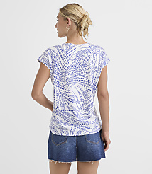 A woman in a white and blue patterned t-shirt and denim shorts stands against a plain white background. carousel Product Image 3